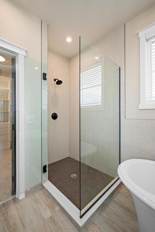 bathroom with separate shower and tub