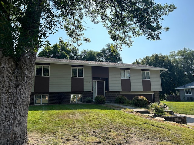 raised ranch featuring a front lawn