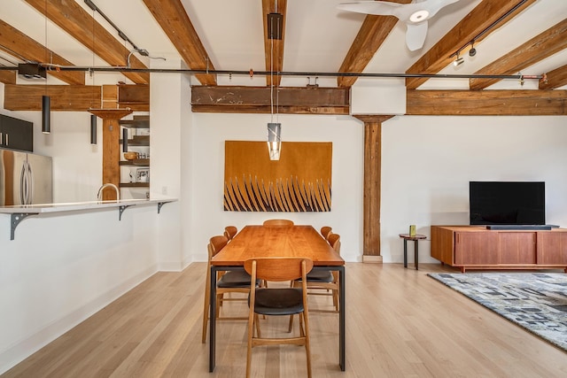 dining room with light hardwood / wood-style flooring, ceiling fan, and beam ceiling