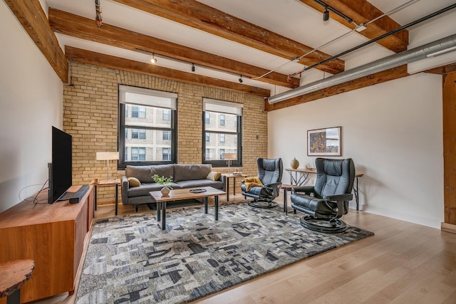 living room with brick wall and light hardwood / wood-style floors