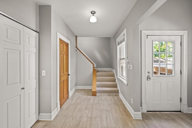 foyer entrance with light hardwood / wood-style flooring