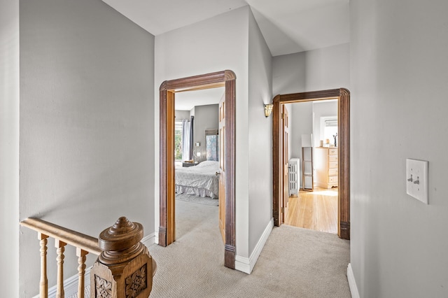 hallway featuring light carpet