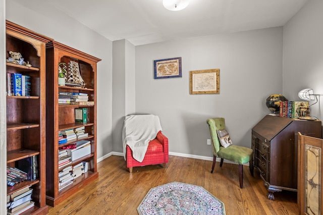 sitting room with hardwood / wood-style flooring