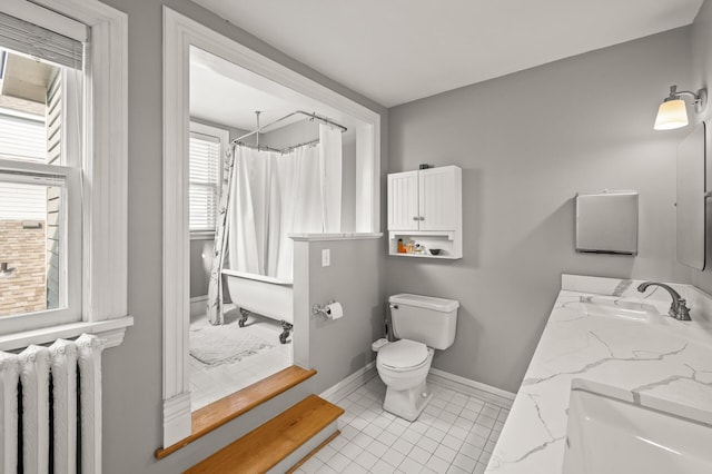 bathroom featuring radiator, vanity, tile patterned flooring, and toilet