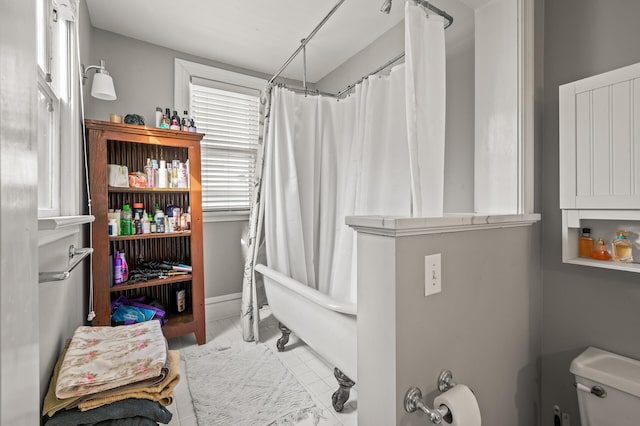 bathroom with shower / bath combo with shower curtain and toilet