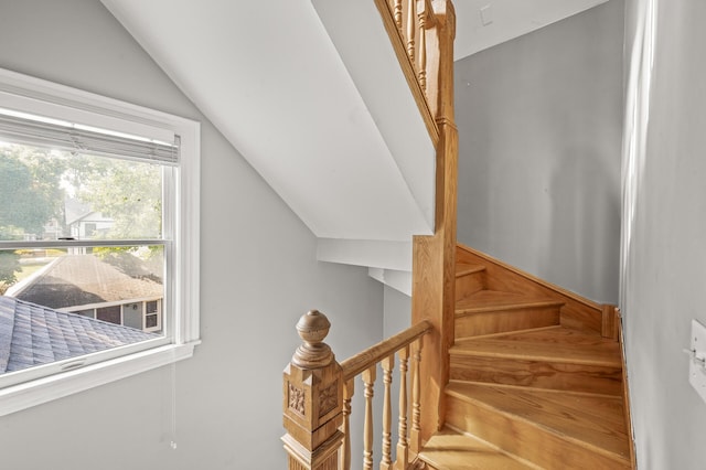 stairway featuring vaulted ceiling