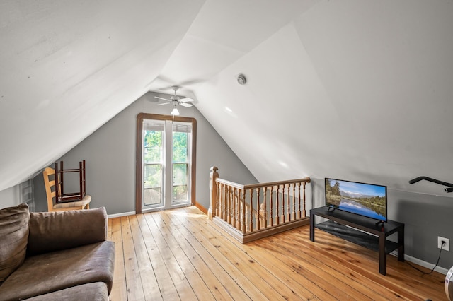 bedroom featuring light wood-type flooring, lofted ceiling, and ceiling fan