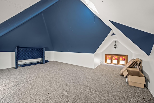 interior space featuring carpet floors and lofted ceiling