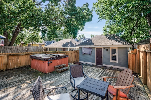 wooden deck featuring a hot tub