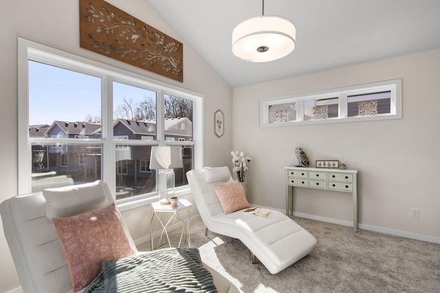 living area featuring lofted ceiling and carpet