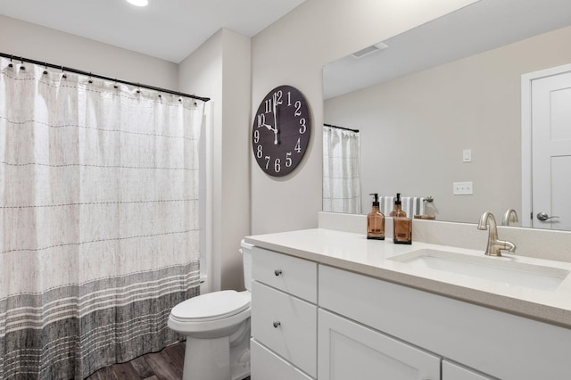 bathroom with vanity, hardwood / wood-style flooring, curtained shower, and toilet