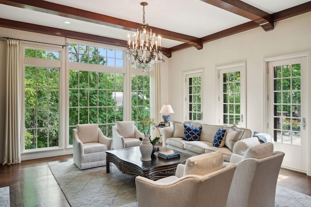 living room with wood-type flooring, beam ceiling, and an inviting chandelier