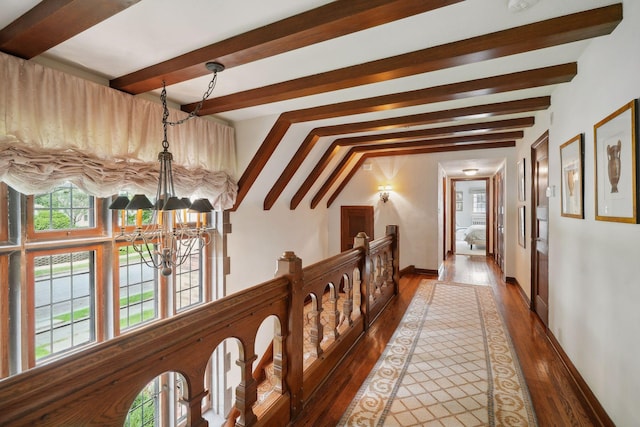 hallway with wood-type flooring, beamed ceiling, and a notable chandelier