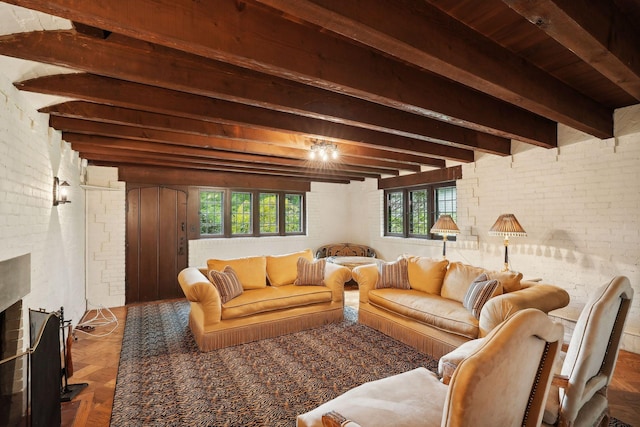 living room featuring brick wall, beamed ceiling, plenty of natural light, and a fireplace