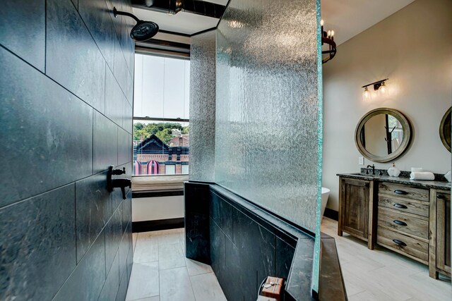 bathroom featuring vanity, tile patterned floors, and tile walls