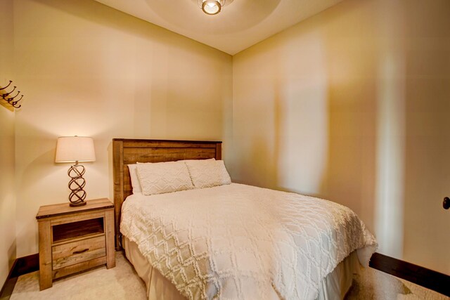 bedroom with light colored carpet and ceiling fan