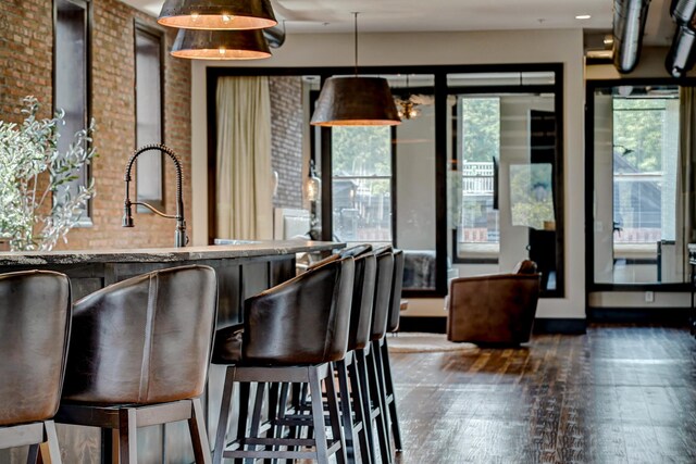 dining area featuring dark hardwood / wood-style flooring and indoor wet bar