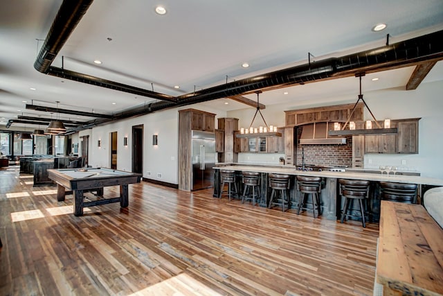 game room featuring wood-type flooring, a notable chandelier, and billiards