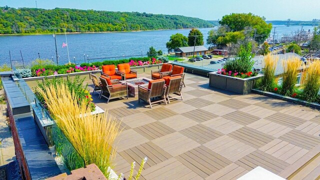 view of patio featuring a water view and a fire pit