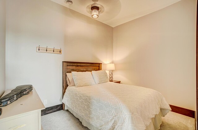 bedroom featuring ceiling fan and light colored carpet