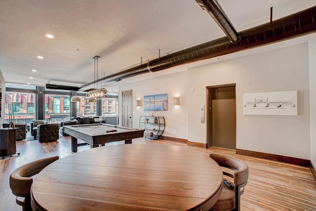 recreation room with light wood-type flooring, elevator, and billiards