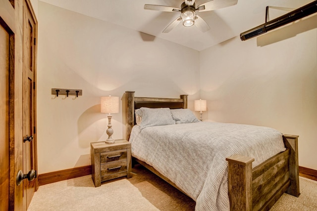 bedroom with ceiling fan and light carpet