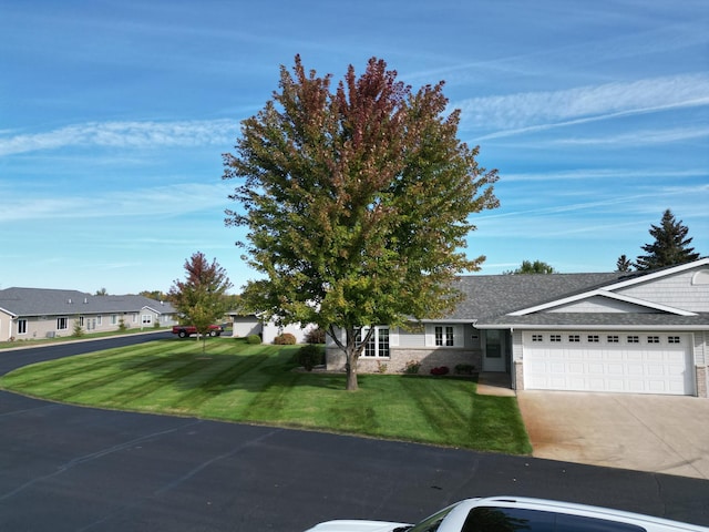 view of front facade with a front lawn and a garage