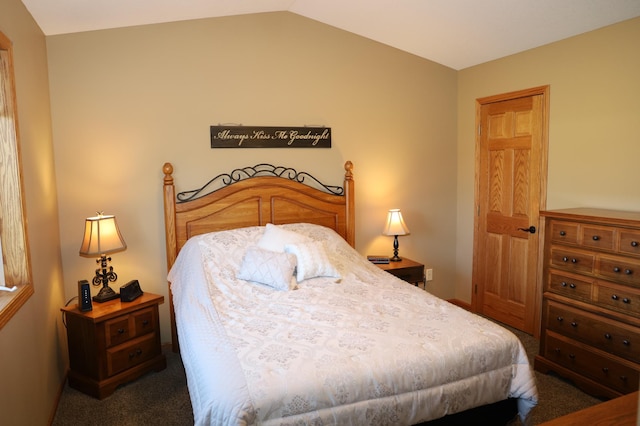 carpeted bedroom with vaulted ceiling