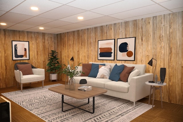 living room featuring parquet flooring, a paneled ceiling, and wooden walls