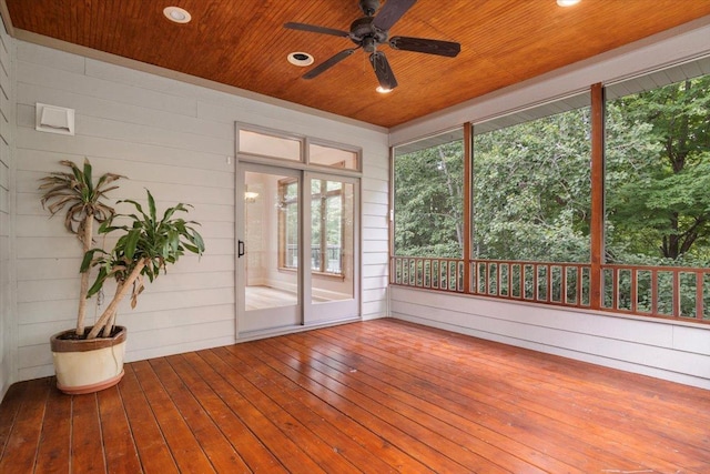 unfurnished sunroom with ceiling fan and wooden ceiling