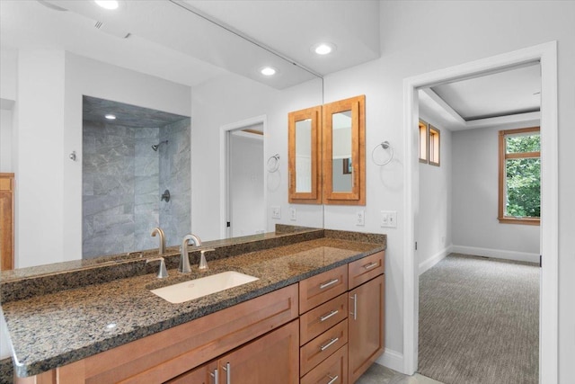 bathroom featuring vanity and a tile shower