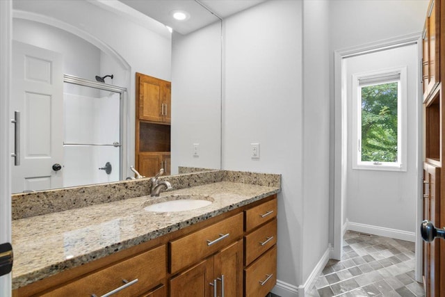 bathroom featuring a shower and vanity