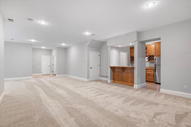 unfurnished living room with light carpet