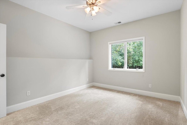 interior space featuring light carpet and ceiling fan