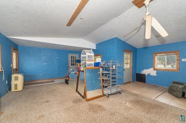 carpeted office with lofted ceiling and a textured ceiling