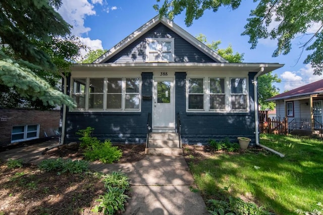 bungalow-style house with a front lawn