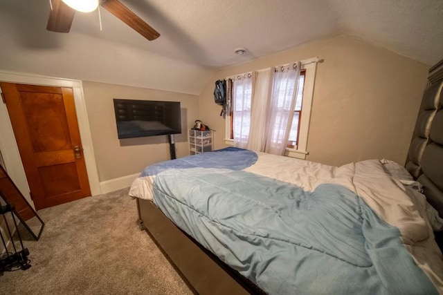 bedroom with ceiling fan, carpet floors, and lofted ceiling