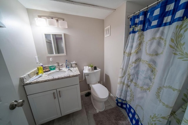 bathroom with tile patterned floors, vanity, curtained shower, and toilet