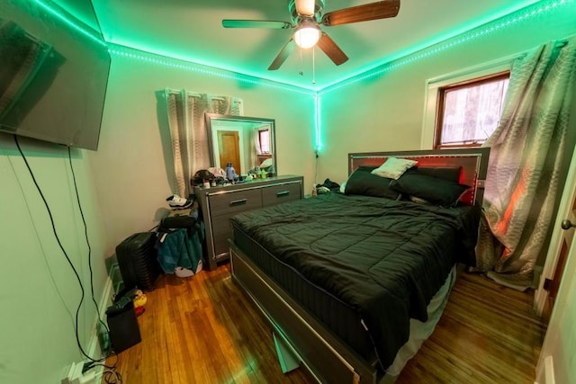 bedroom featuring ceiling fan and dark hardwood / wood-style flooring