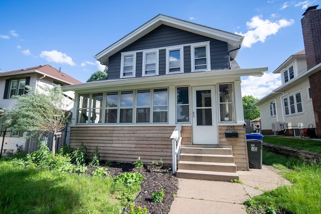 view of front of property with a sunroom