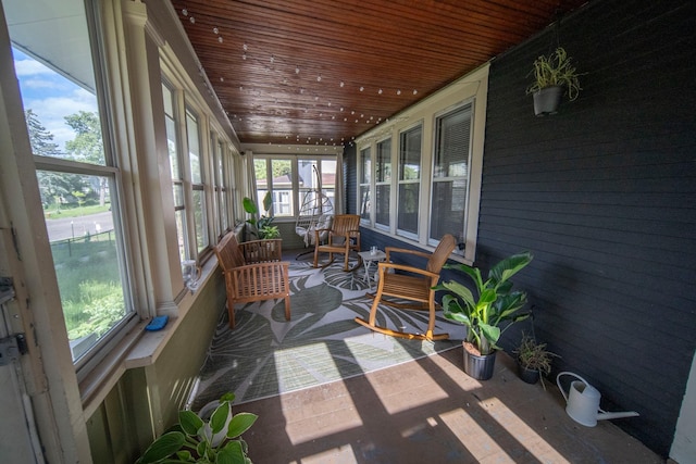 sunroom featuring a wealth of natural light and wood ceiling