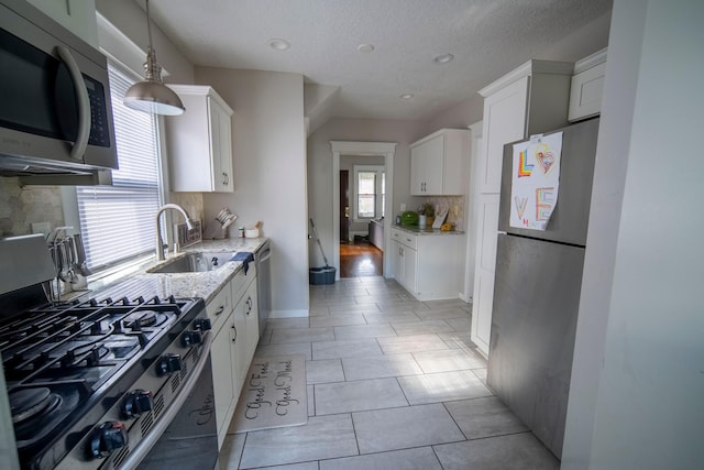 kitchen featuring white cabinetry, sink, and appliances with stainless steel finishes