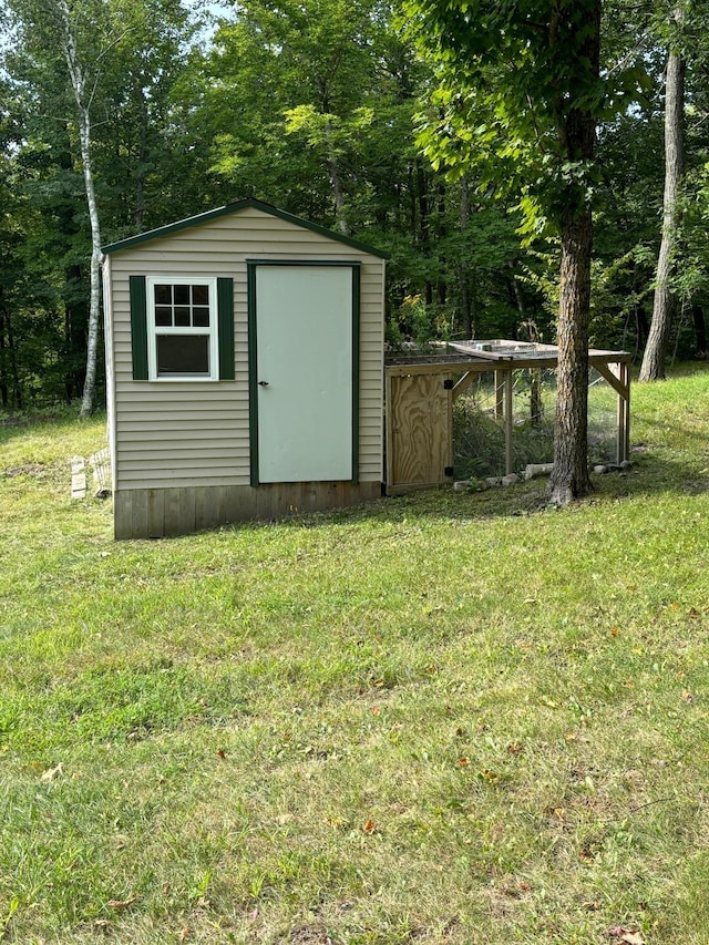 view of outbuilding with a lawn