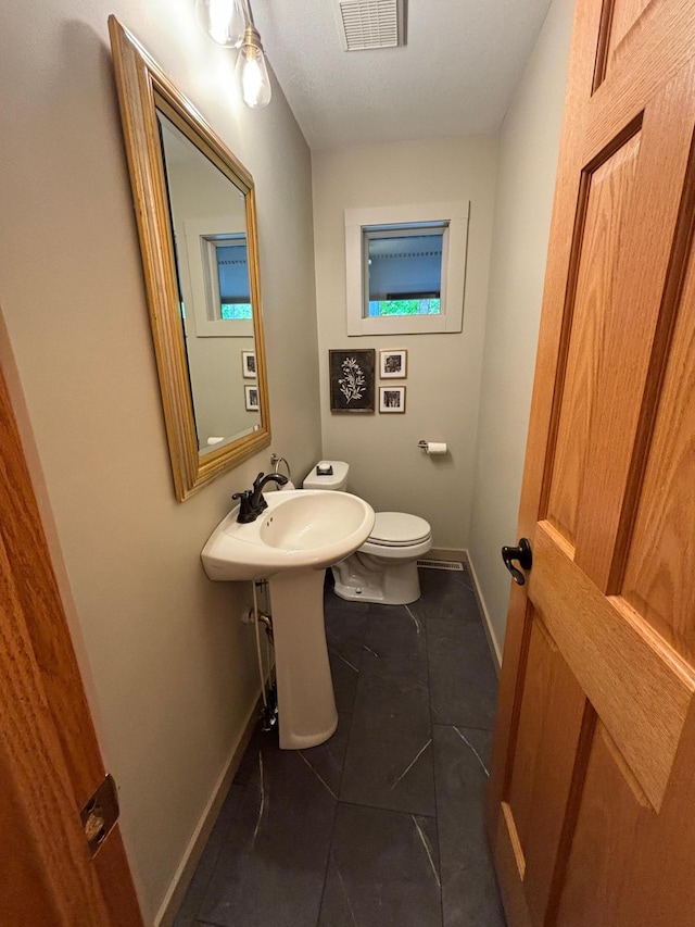 bathroom with tile patterned flooring and toilet