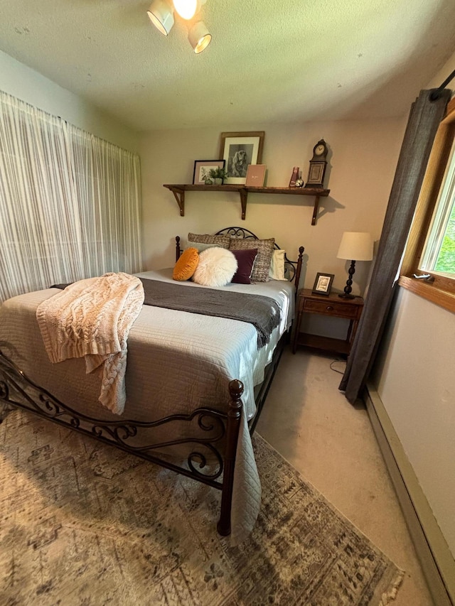 carpeted bedroom with a textured ceiling