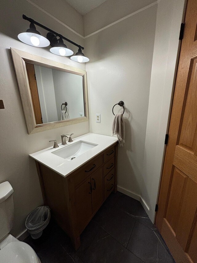 bathroom with tile patterned flooring, vanity, and toilet