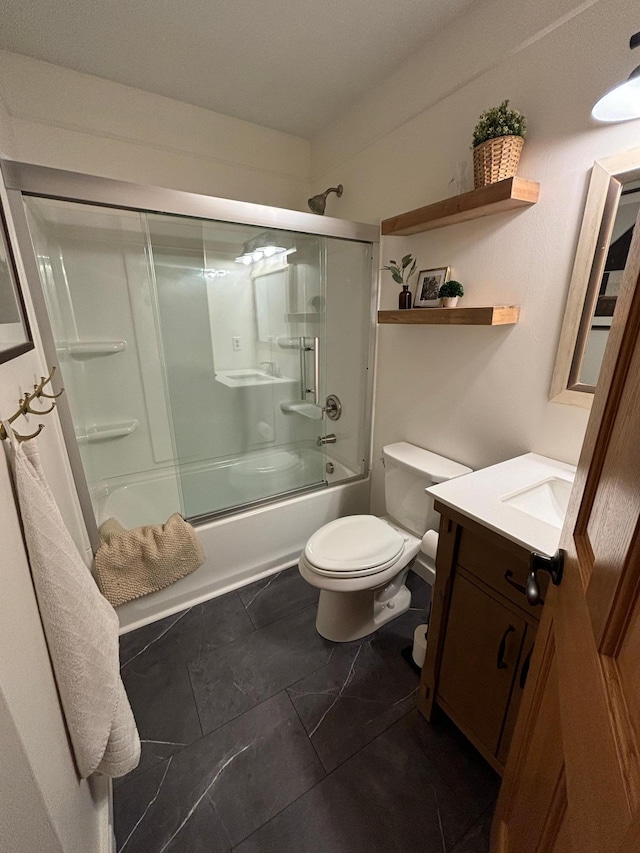 full bathroom with shower / bath combination with glass door, vanity, and toilet