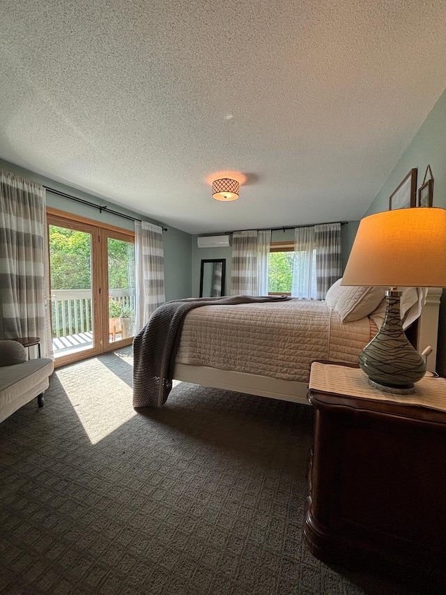 carpeted bedroom with access to exterior, a wall mounted air conditioner, and a textured ceiling