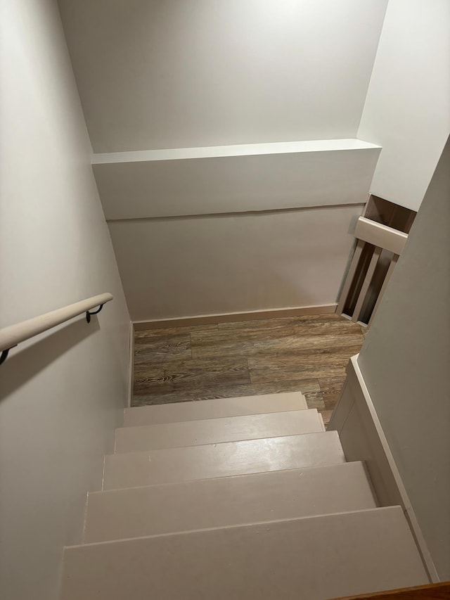 stairway featuring hardwood / wood-style floors