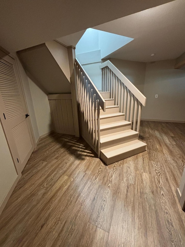 stairs with hardwood / wood-style flooring